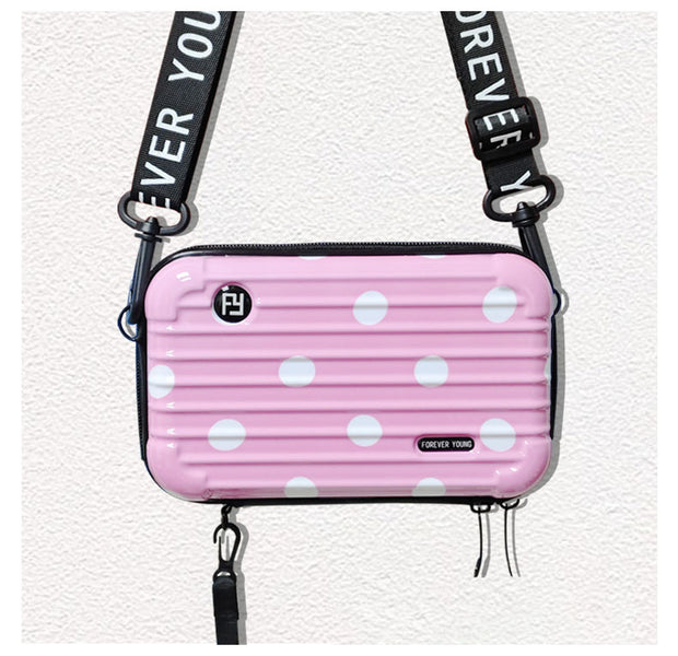 Mini-valise à bandoulière.